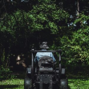 Person mowing a lush lawn with a tractor in Atlanta, GA.